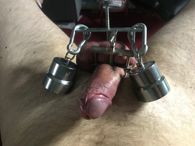 Mistress Vivienne lAmour attaches cock and ball clamps and heavy weights to an unlucky slave